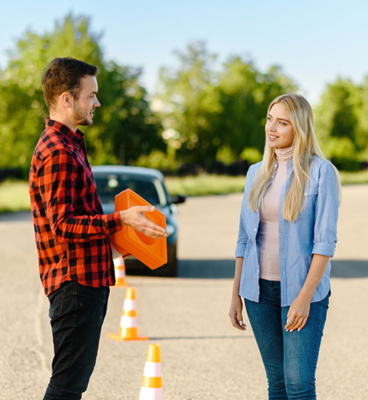 Male instructor with traffic cone and student